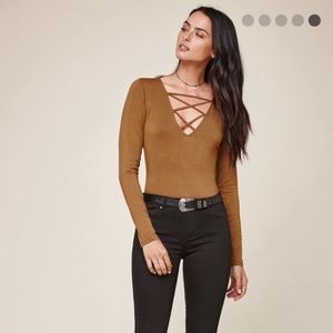 Tan long sleeve top.